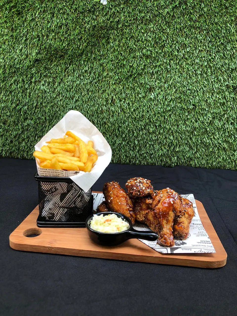 Glazed chicken wings with fries and coleslaw